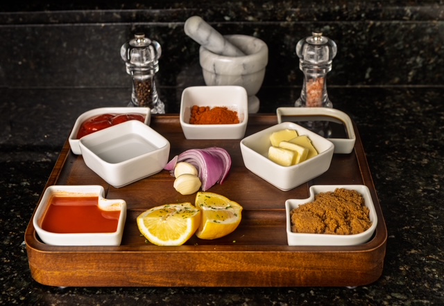 Ingredients laid out in white dishes on a wooden tray